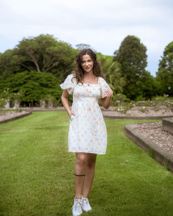 Aria Babydoll Dress — white broderie anglaise mini dress with pastel florals, front full view | La Mira Singapore